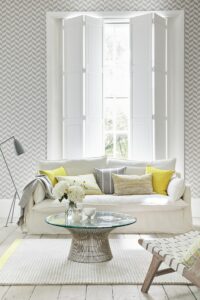 Grey and yellow lounge with white shutters