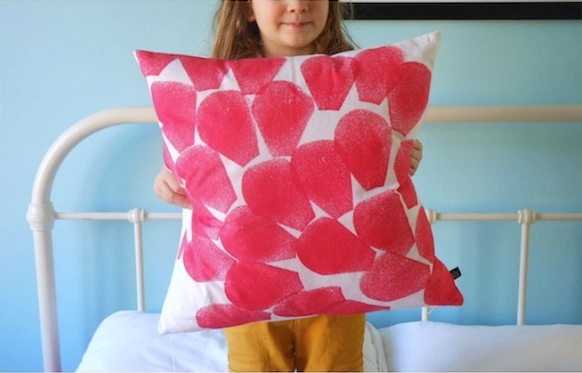 Girl holding a red pattern cushion 